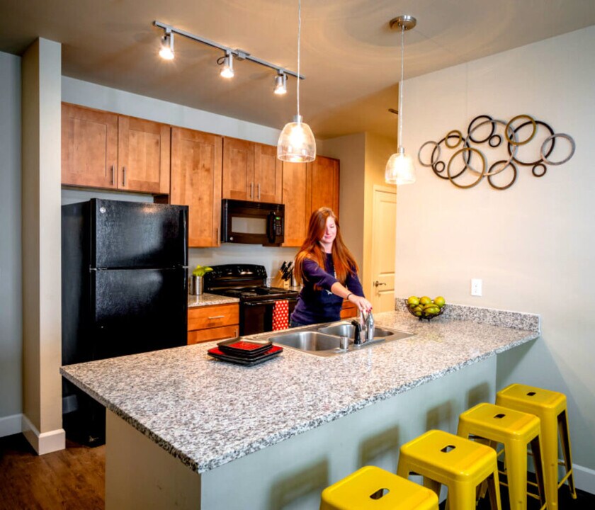 Student using furnished kitchen in Stadium View Apartments